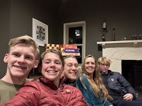 a group of people posing for a selfie in a living room
