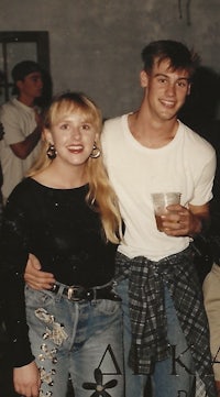 a man and woman standing next to each other at a party